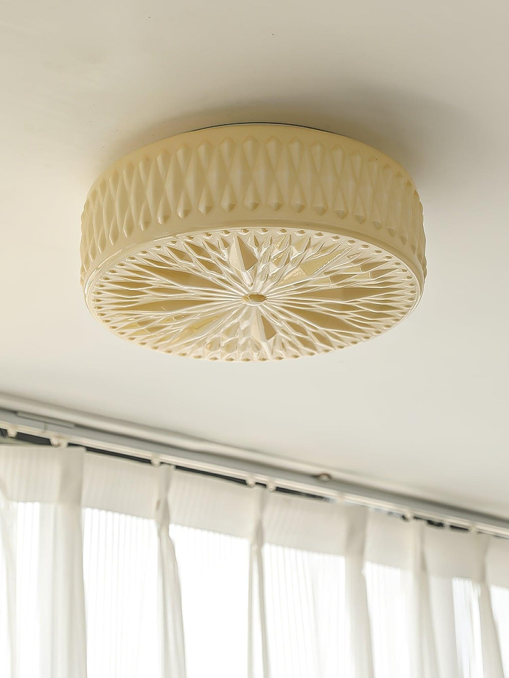 Adler ceiling light shown lit in a kitchen setting