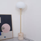 Another view of the Clérachic floor lamp in the same white corner, beside the leaning abstract artwork.
