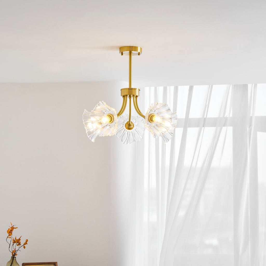 Sunlight through a curtain catches the brass frame and petal shades of this Clérachic chandelier.