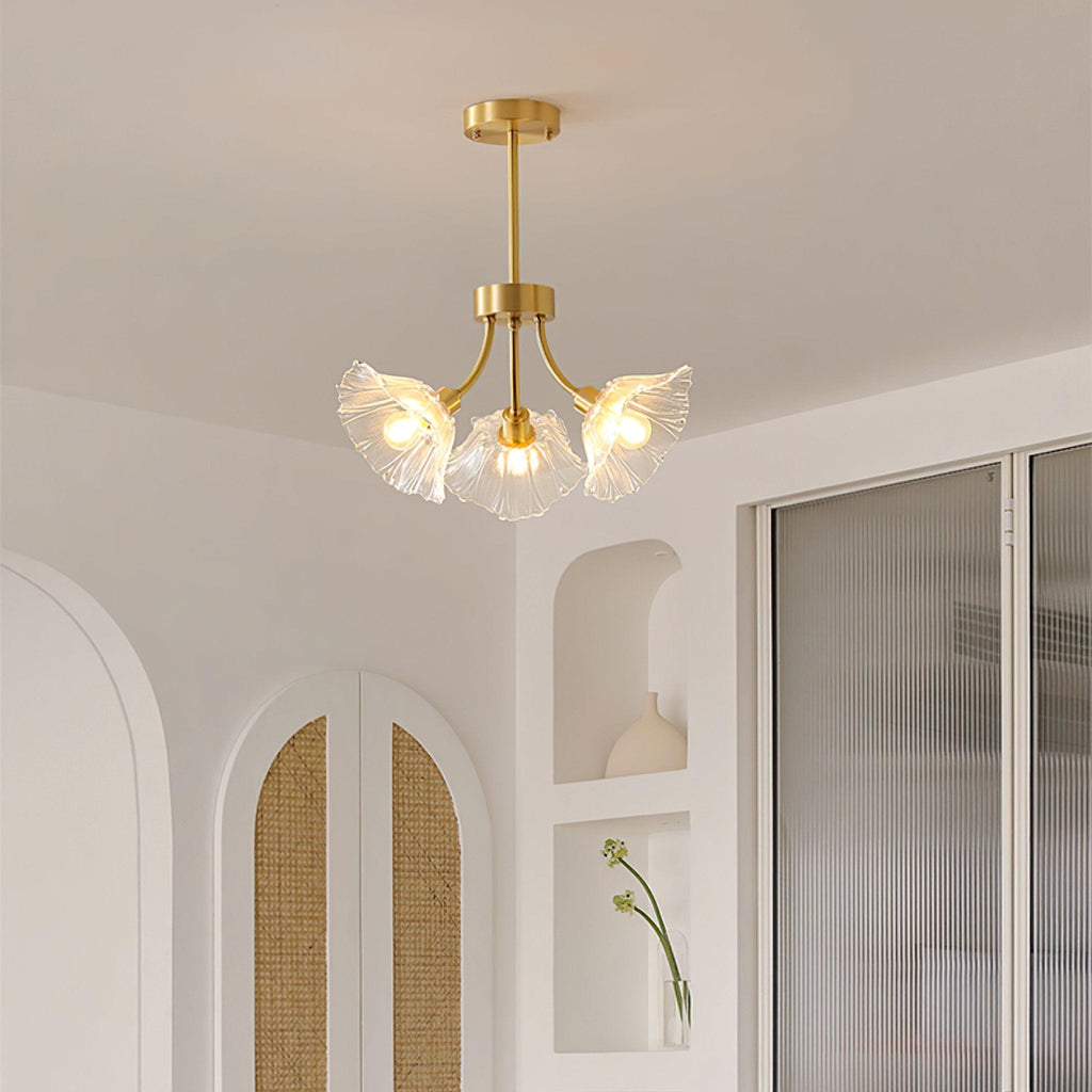 An arched, cane-panelled alcove sits beside this Clérachic chandelier, which hangs near a sheer curtain.