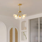 An arched, cane-panelled alcove sits beside this Clérachic chandelier, which hangs near a sheer curtain.