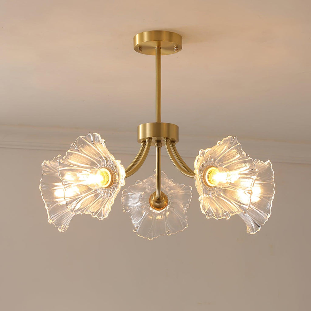 A closer angle against a grey wall shows three of this Clérachic chandelier's ruffled glass petal shades lit softly.