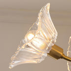 Close-up of a single ruffled glass petal shade on this Clérachic chandelier, showing its swirled texture and lit bulb.