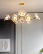 Another angle against grey walls shows this Clérachic chandelier's brass frame with its glass petal shades spread wide.
