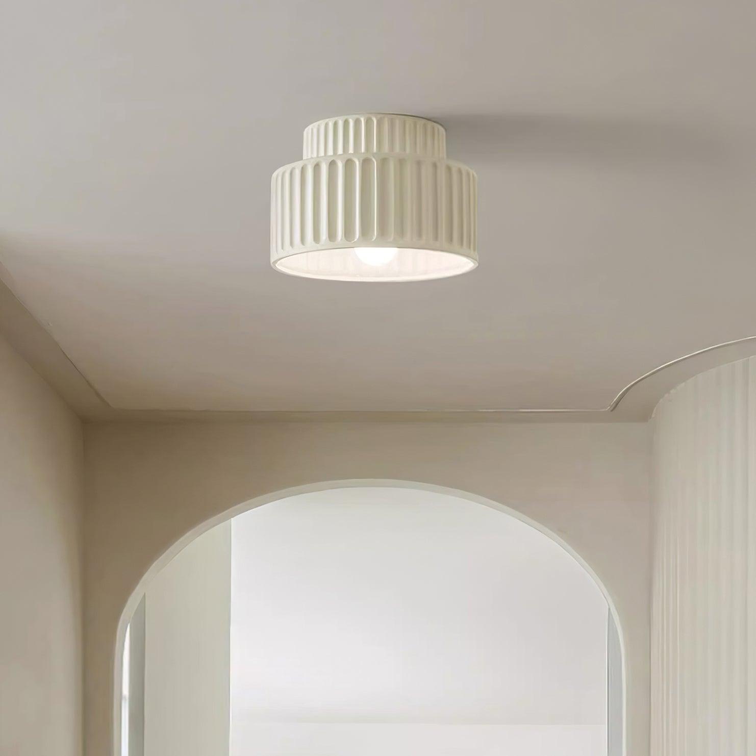 Pleated resin ceiling light in beige with soft ambient glow