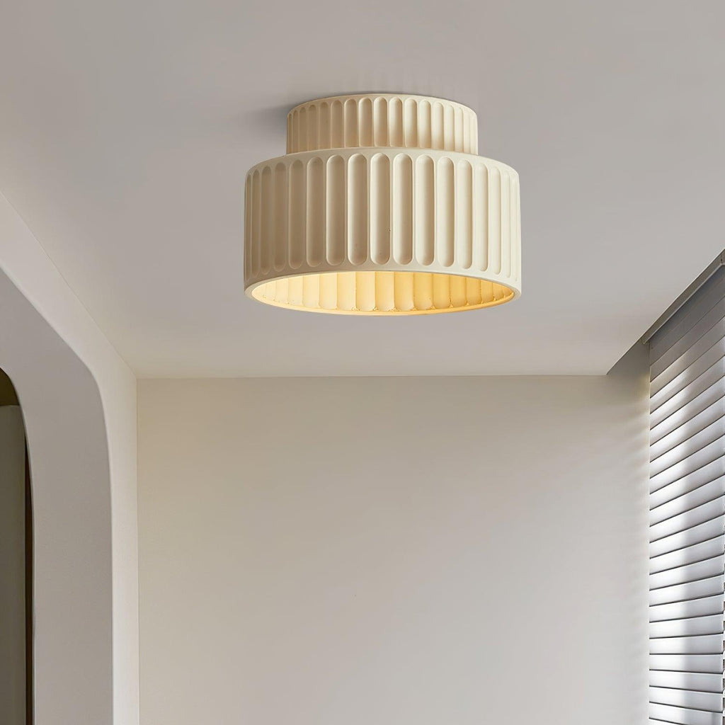 Pleated resin ceiling light with soft luminous glow in a bedroom