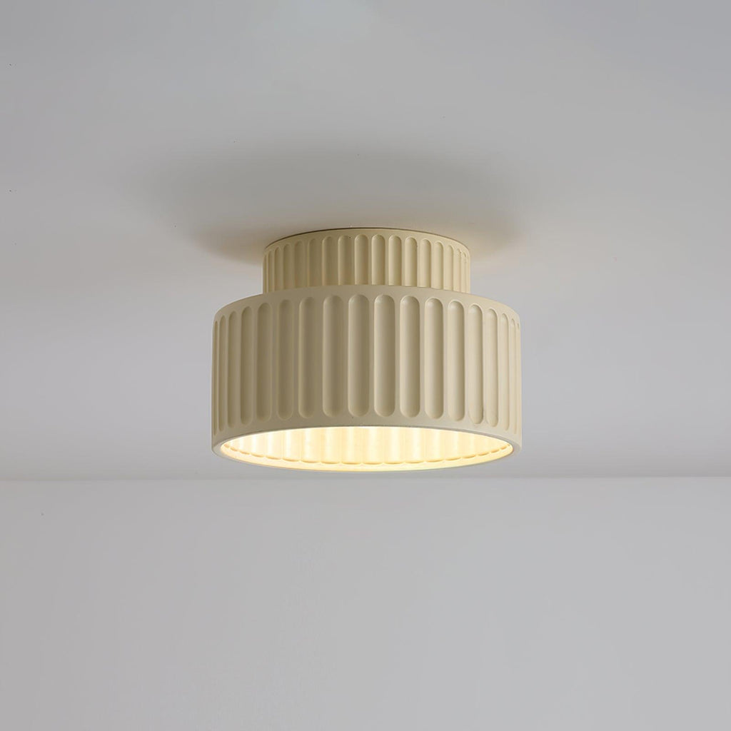 Pleated resin ceiling light casting warm even light in a room