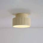 Pleated resin ceiling light casting warm even light in a room