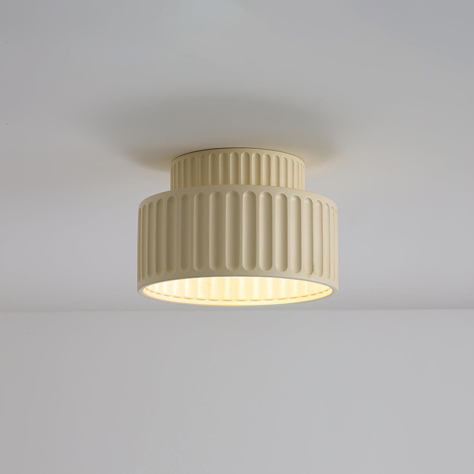 Pleated resin ceiling light casting warm even light in a room