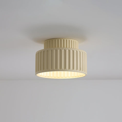 Pleated resin ceiling light casting warm even light in a room