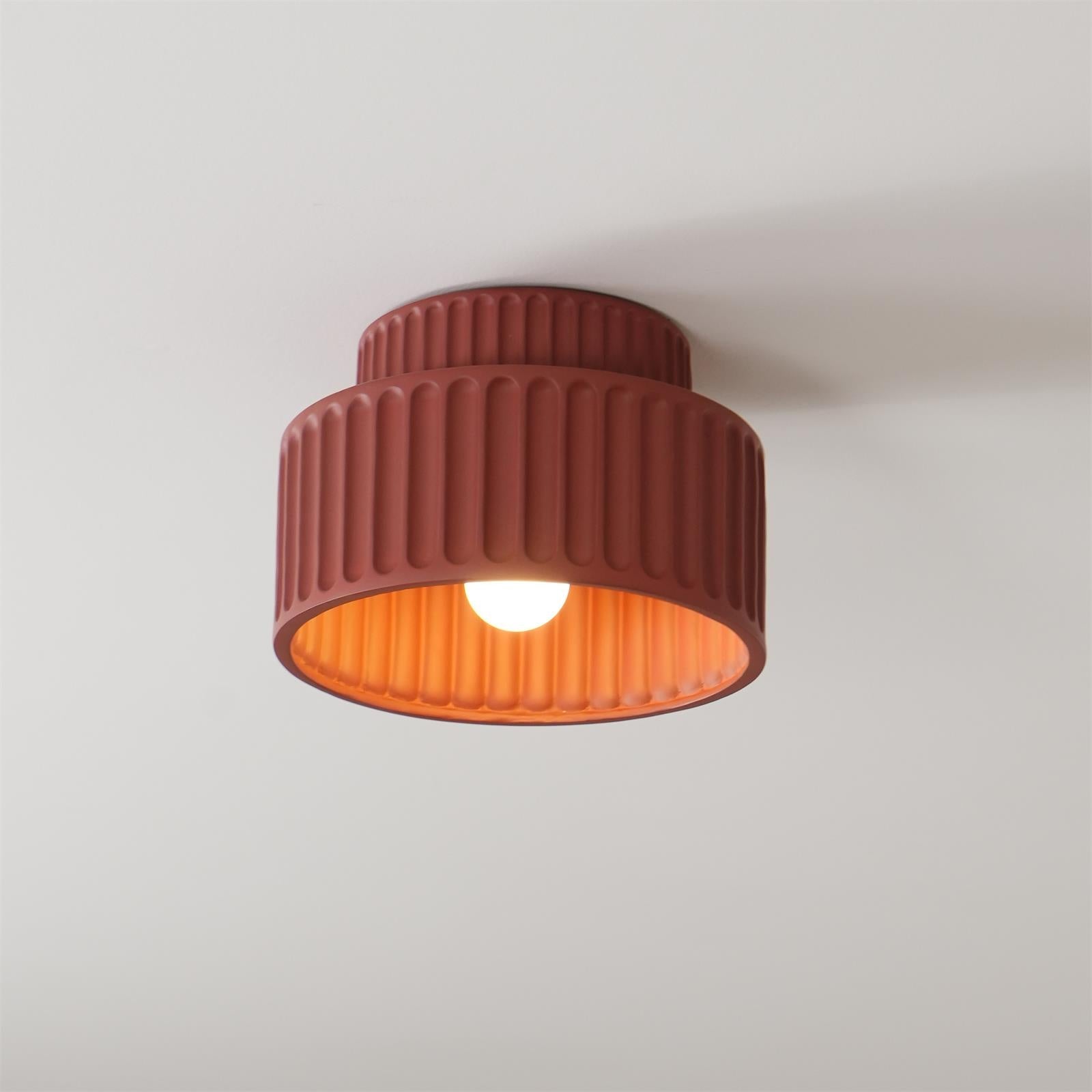 Pleated resin ceiling light with warm globe and soft ambient light