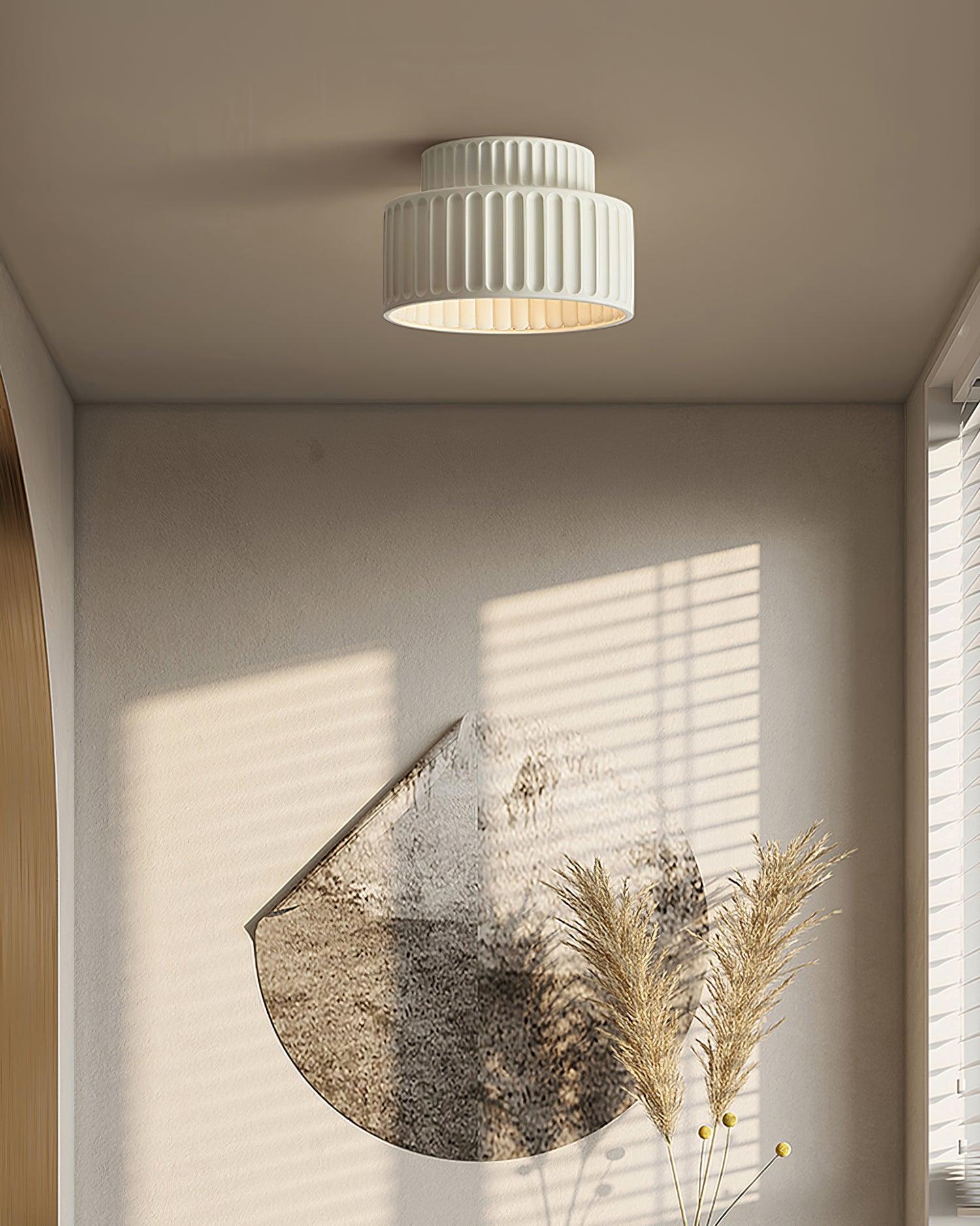 Pleated resin ceiling light with warm globe and pleated detailing