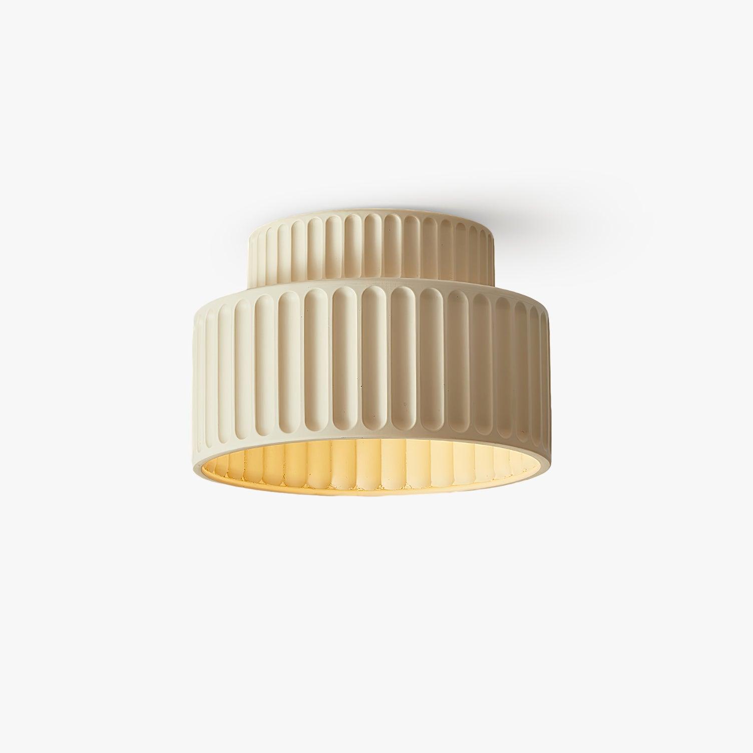 Pleated resin ceiling light shown close with textured shade