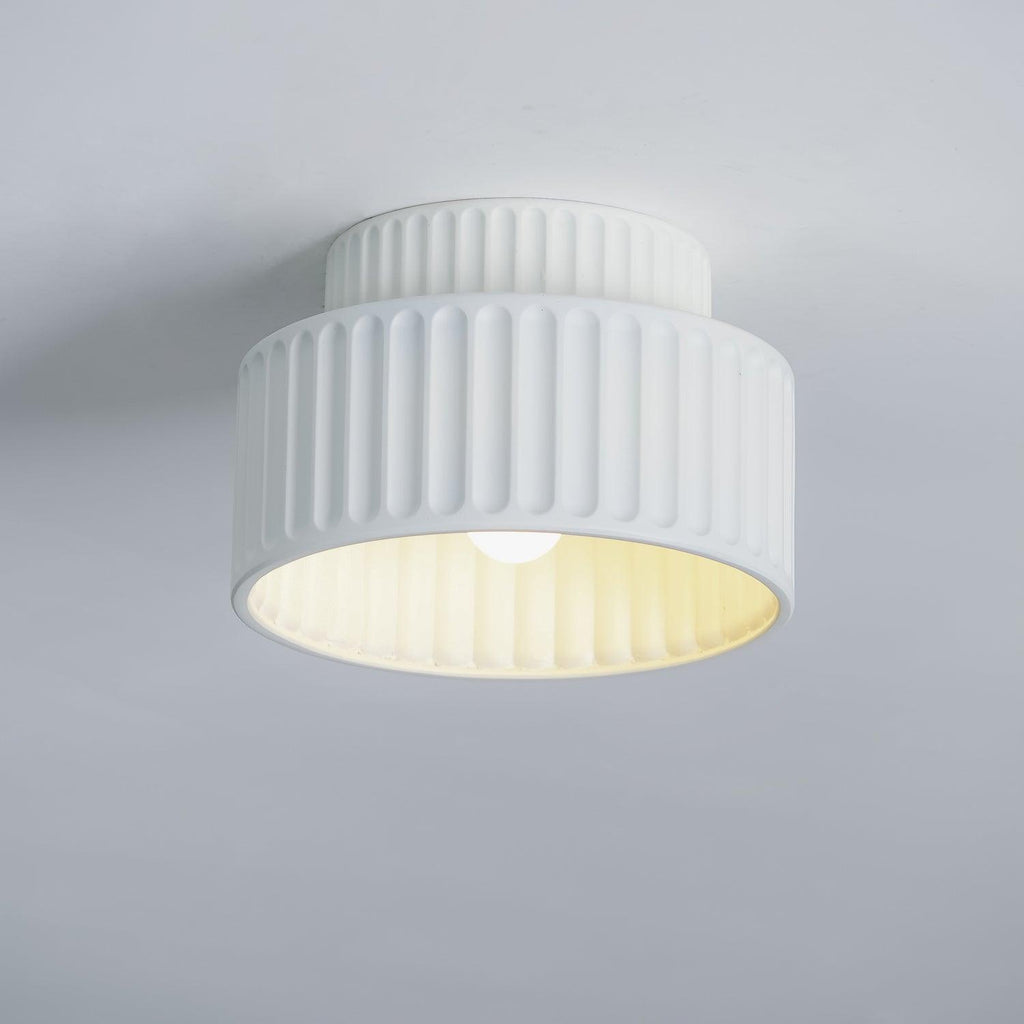 Pleated resin ceiling light in orange with soft warm glow