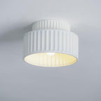 Pleated resin ceiling light in orange with soft warm glow