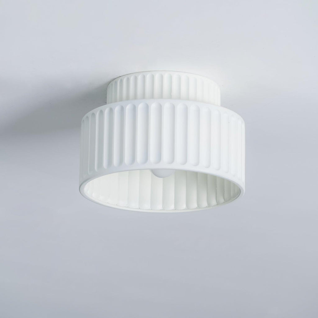 Pleated resin ceiling light with textured shade in a living space