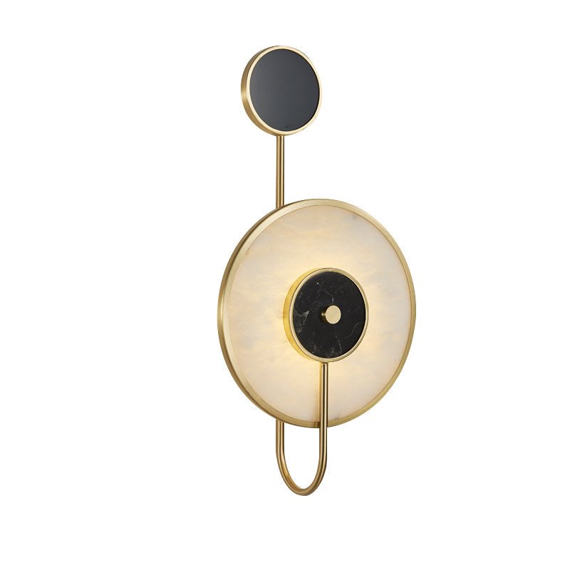 The inverted layout on white, small black disc above and the larger alabaster disc below.