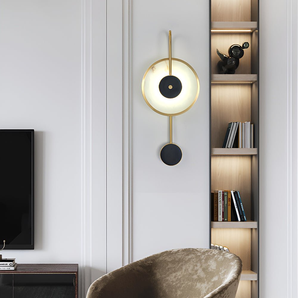 Lit in a living room beside a lit bookshelf, a velvet armchair below and a television left.