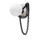 A white-and-grey veined marble disc appears on the Clérachic sconce here, matched with a black chain and finial.