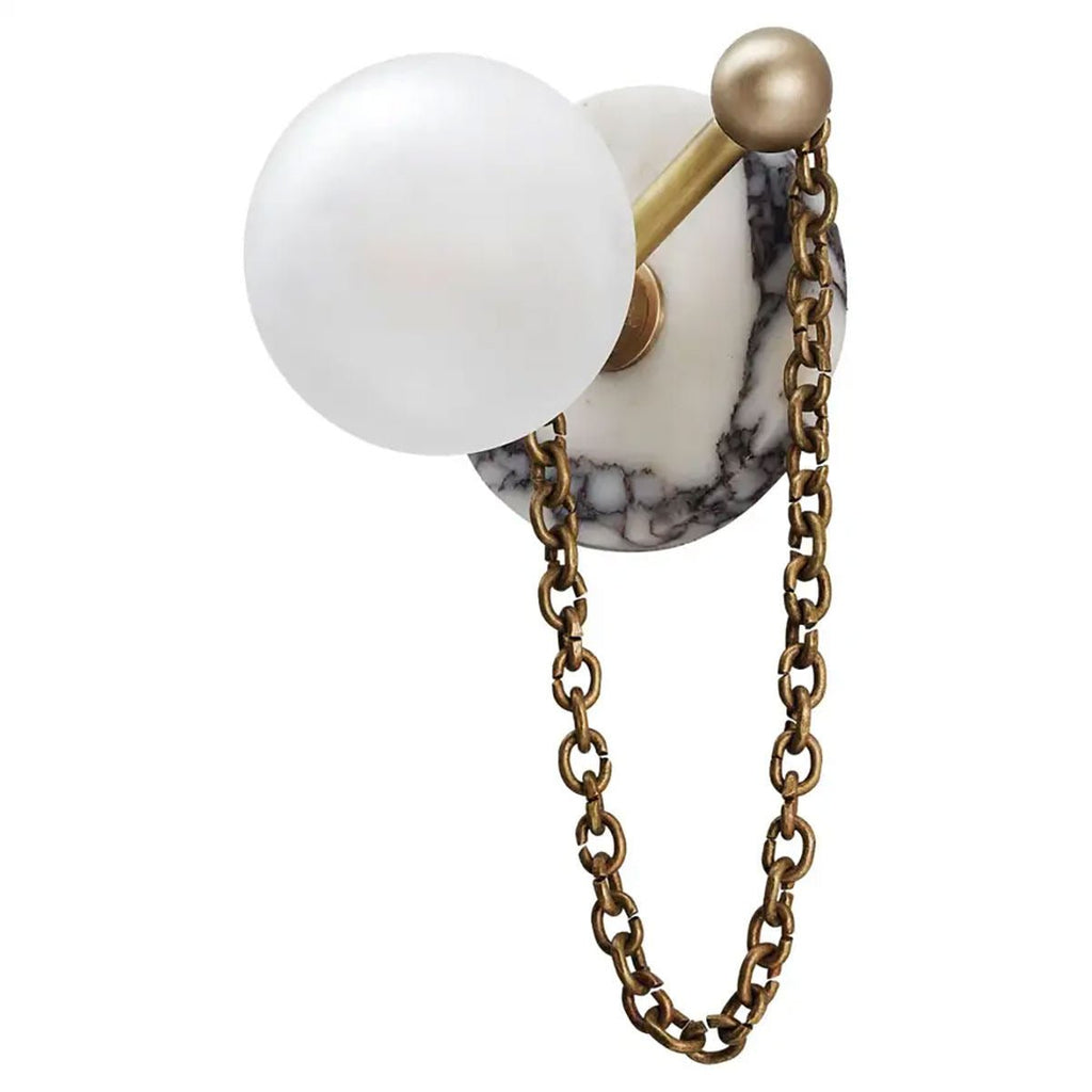 The same veined marble disc is shown on the Clérachic sconce, paired with an antique-brass chain and finial instead.