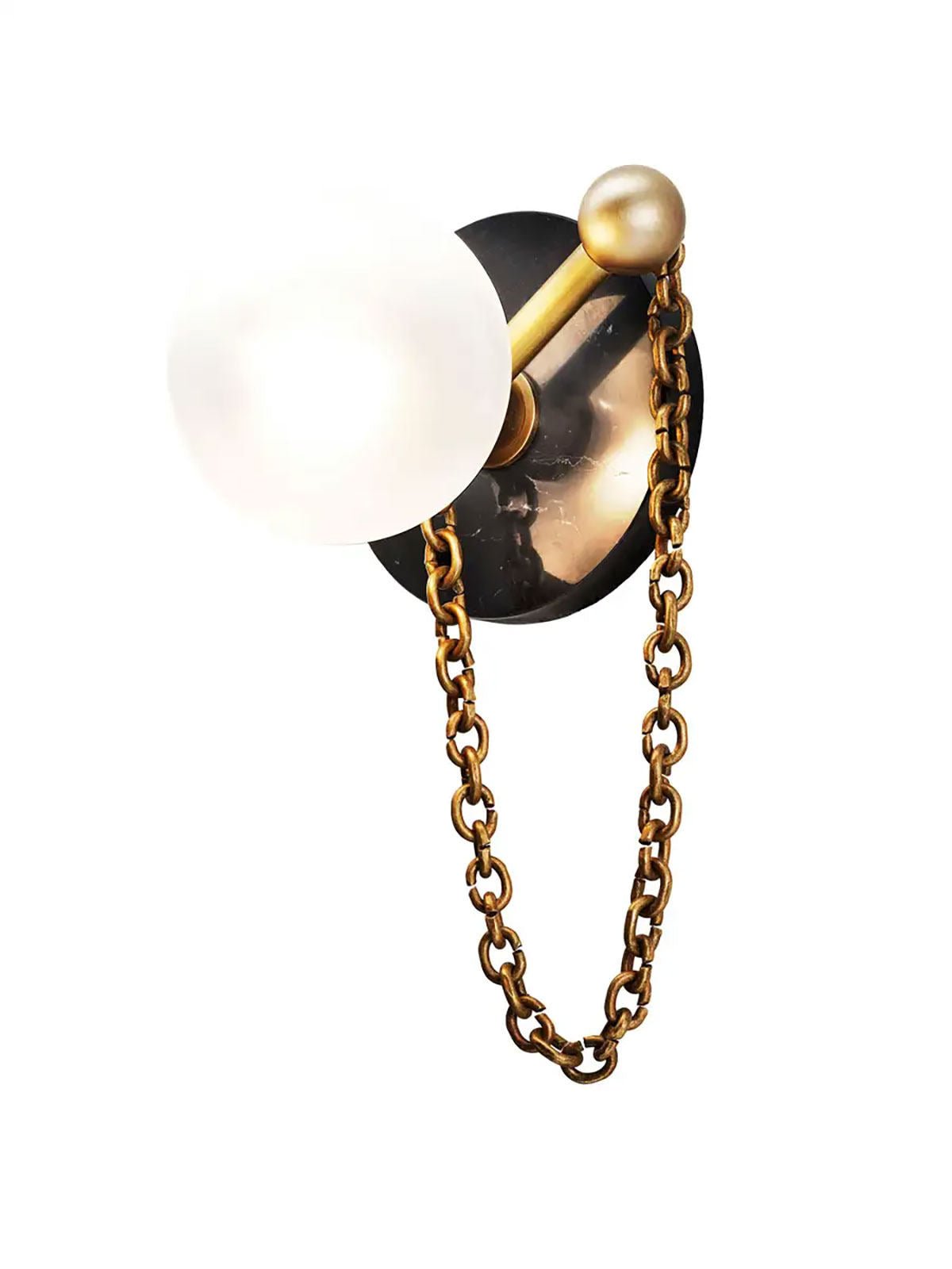 This close detail view shows the Clérachic sconce's dark glossy disc with an antique-brass chain and ball finial.
