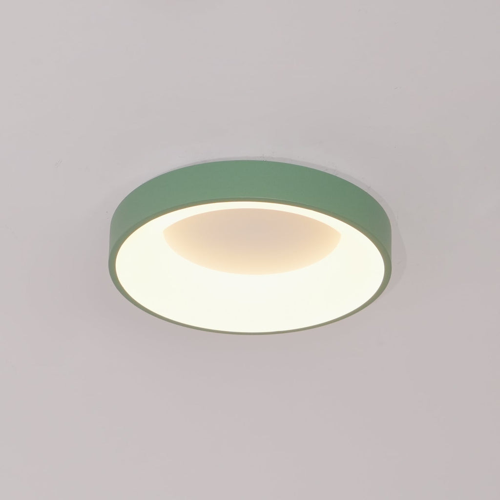 Slim white flush mount ceiling light glowing evenly overhead