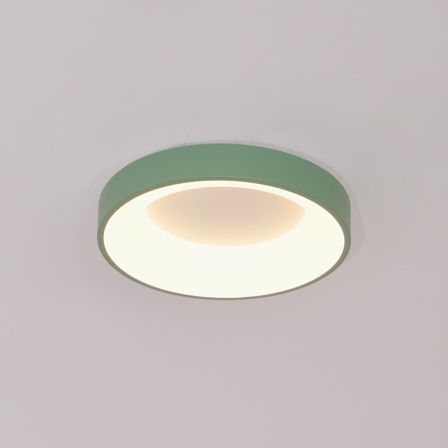 Slim white flush mount ceiling light glowing evenly overhead