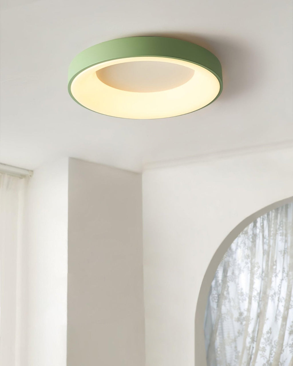 White flush mount ceiling light lit evenly across the diffuser