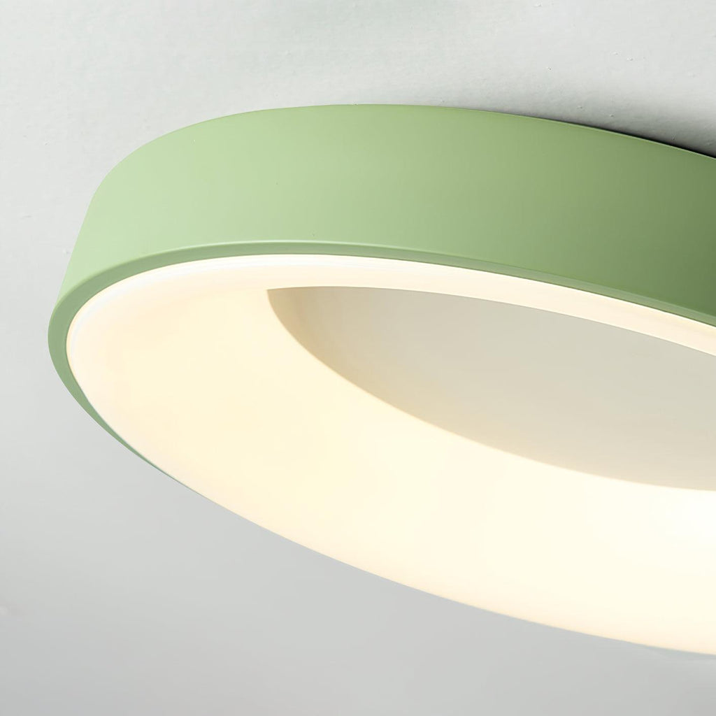 Round flush mount ceiling light shown lit in a hallway