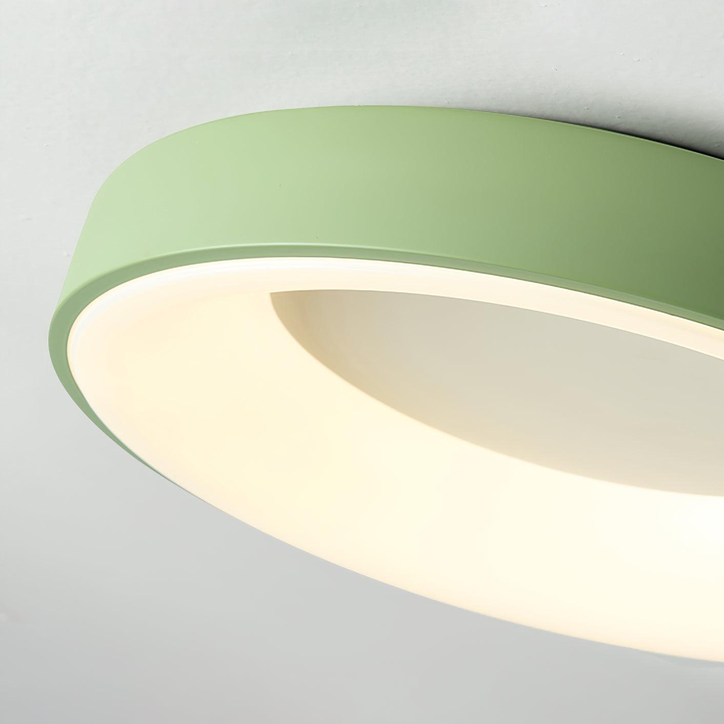 Round flush mount ceiling light shown lit in a hallway