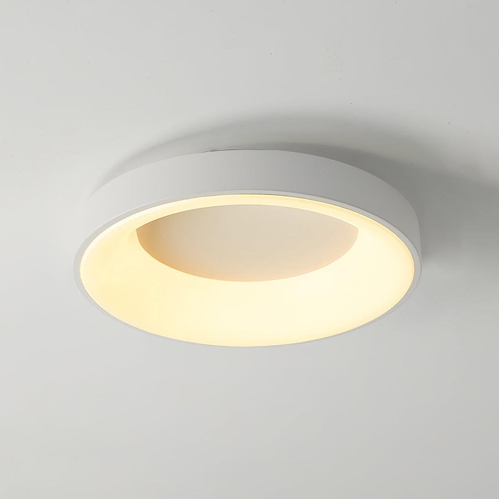 White round flush mount ceiling light shown lit and even
