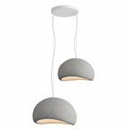 Wabi-sabi organic chandelier casting warm light in a calm interior