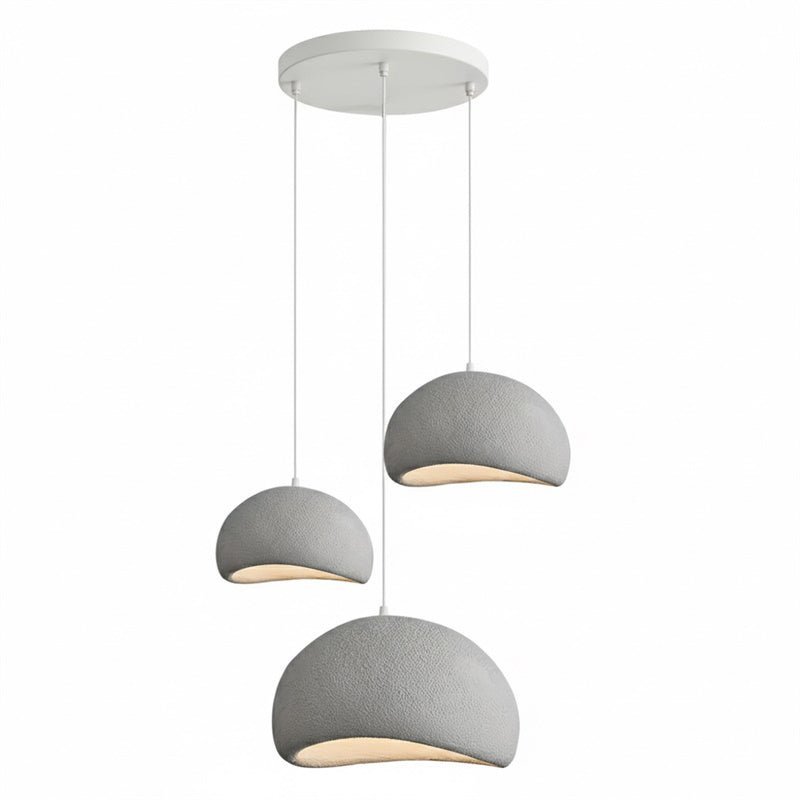 Wabi-sabi organic chandelier in a linear configuration over a table