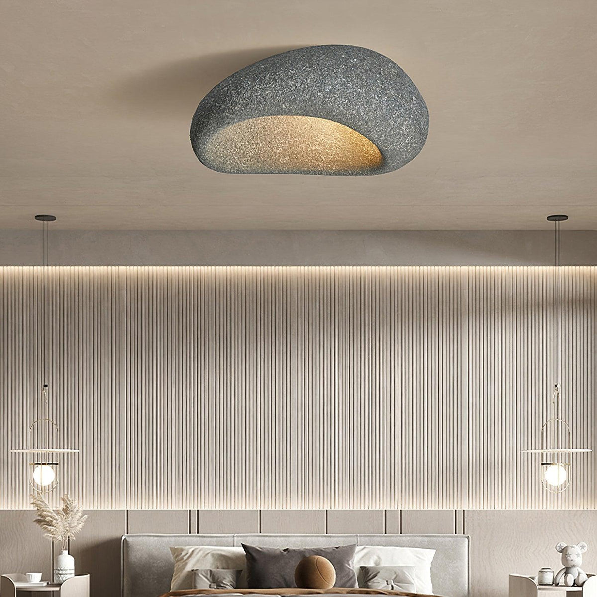 In a dark speckled finish, this Clérachic ceiling light lights a room with a slatted wood wall and two pendant lamps.