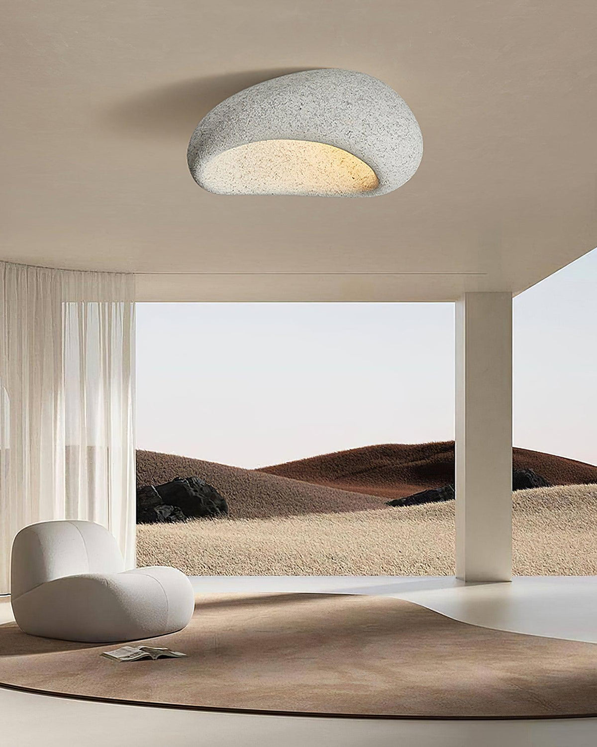 Opening onto a desert landscape view, this Clérachic ceiling light glows in a speckled grey finish.