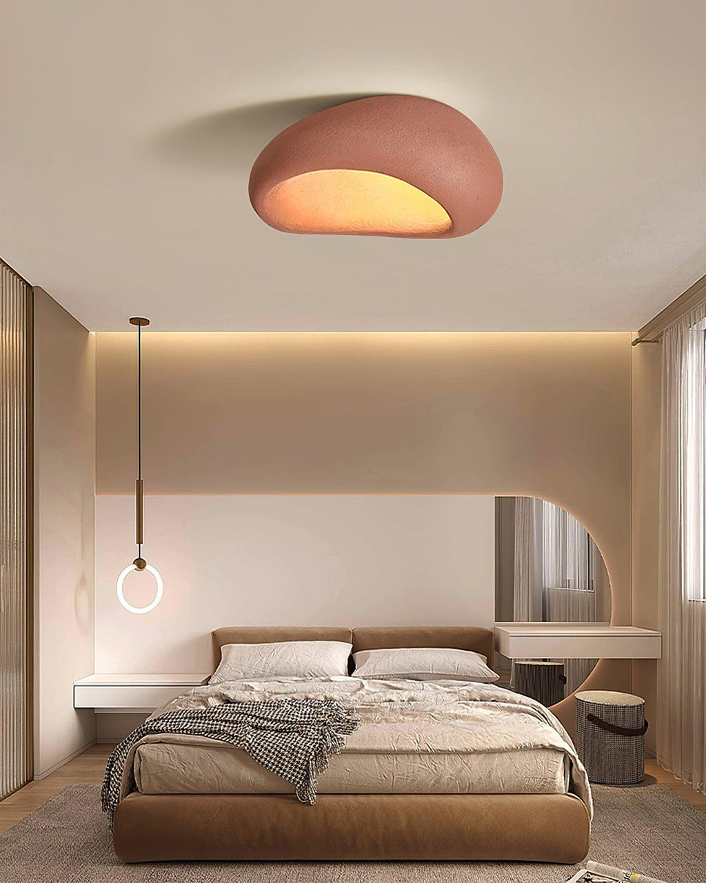 In brick red, this Clérachic ceiling light glows above a bed with a ring pendant lamp and a round mirror nearby.