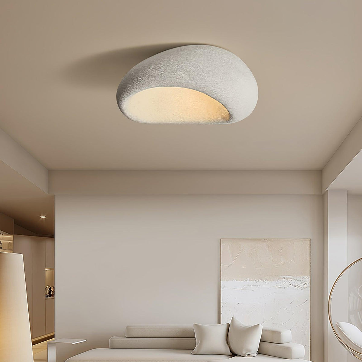 Above a bedroom with framed art and a round mirror, this Clérachic ceiling light glows in white texture.