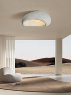 Opening onto the same desert landscape, this Clérachic ceiling light glows in its speckled grey finish overhead.