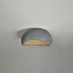 A dark speckled finish glows on this Clérachic ceiling light against a plain grey background.