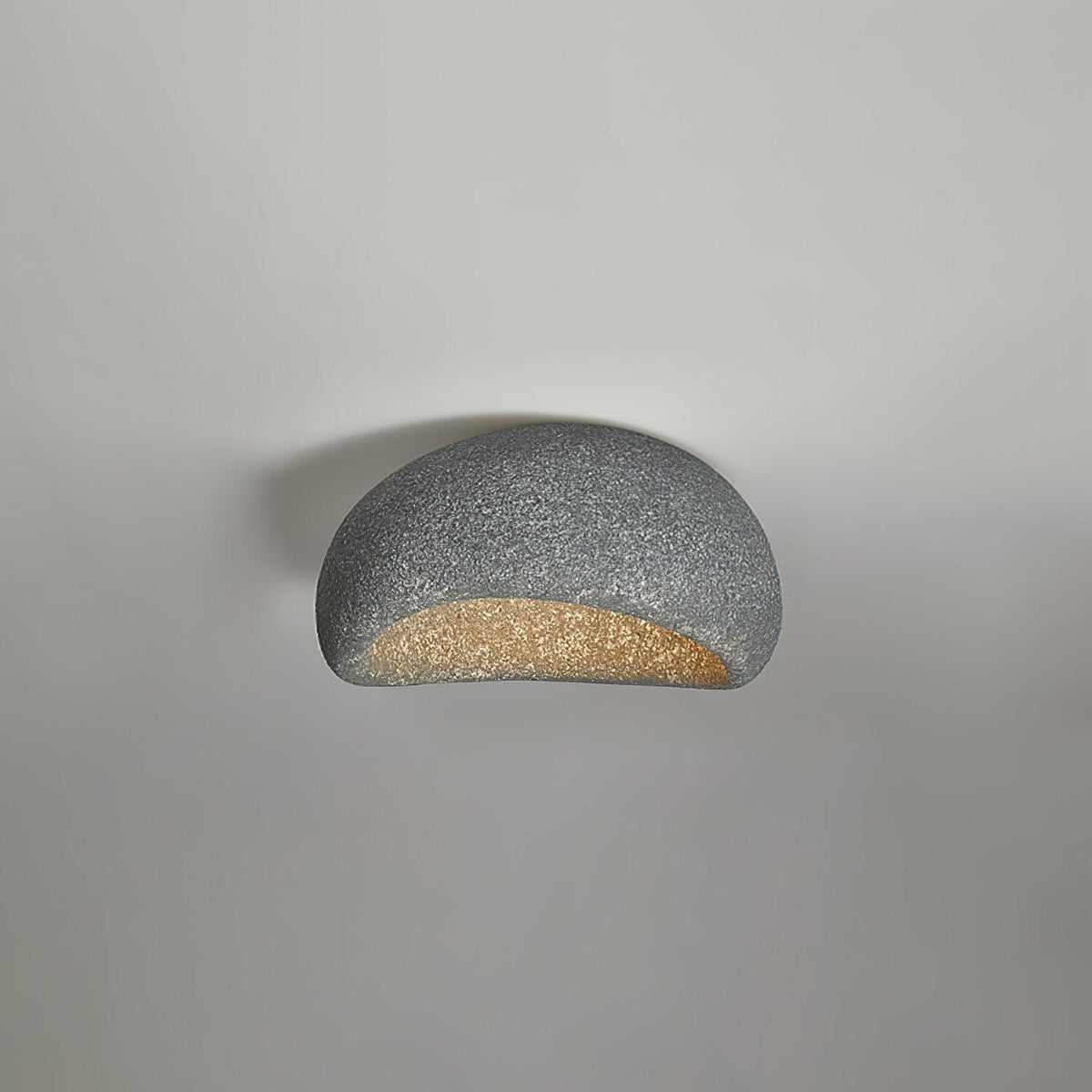 A dark speckled finish glows on this Clérachic ceiling light against a plain grey background.