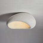 A wider view of this Clérachic ceiling light in its light speckled finish, glowing against plain grey.