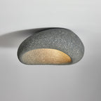 Seen close up, this Clérachic ceiling light glows in a dark speckled finish against plain grey.