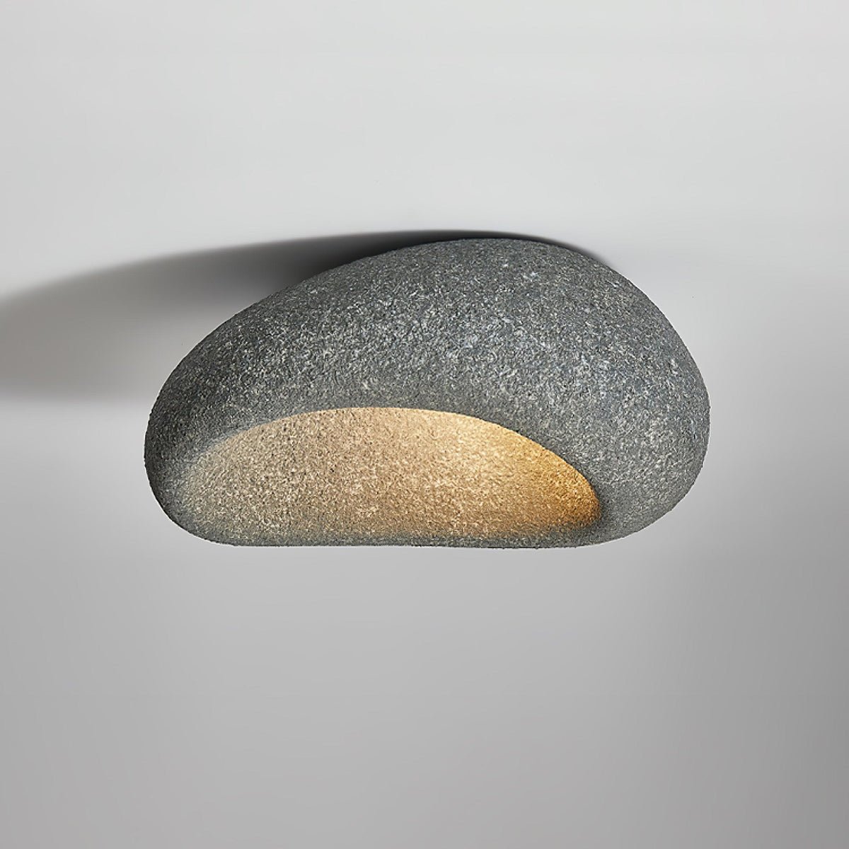 Seen close up, this Clérachic ceiling light glows in a dark speckled finish against plain grey.