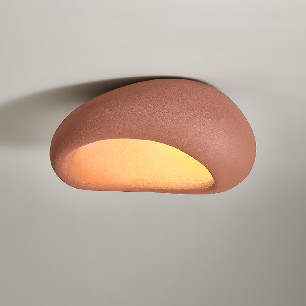 In brick red, this Clérachic ceiling light glows against a plain grey background.