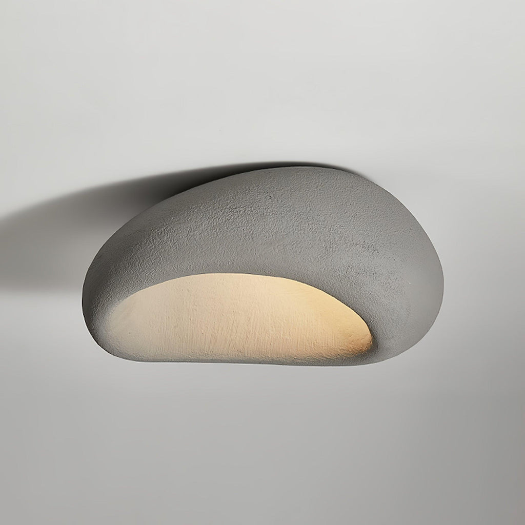 A smooth cement-grey finish glows on this Clérachic ceiling light against a plain grey background.