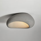 A smooth cement-grey finish glows on this Clérachic ceiling light against a plain grey background.