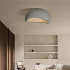 Lit above a shelved alcove with a wooden chair, this Clérachic ceiling light shows its white texture cloud shape.