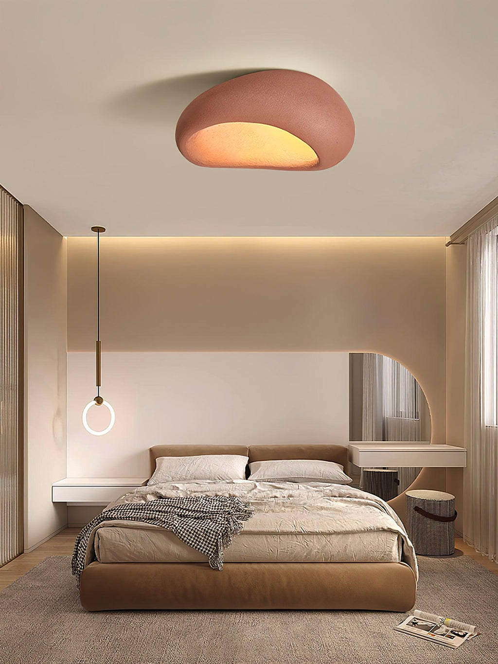 In brick red, this Clérachic ceiling light glows above a bedroom with a ring pendant lamp and round mirror.