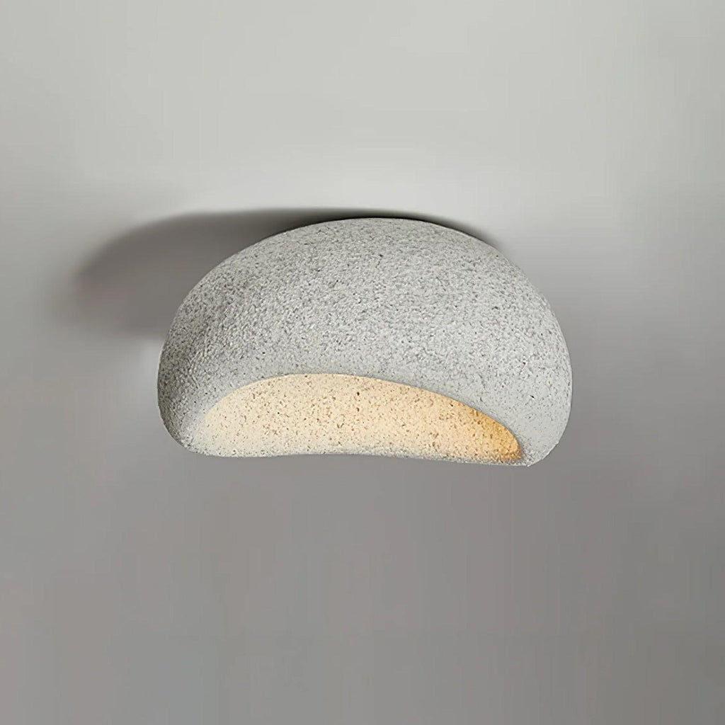 Angled against a plain grey background, this Clérachic ceiling light shows its light speckled finish.