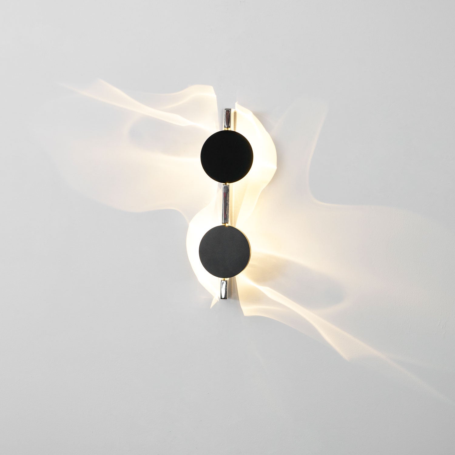 Kinetic Shadow wall lamp with mirrored chrome sculptural body